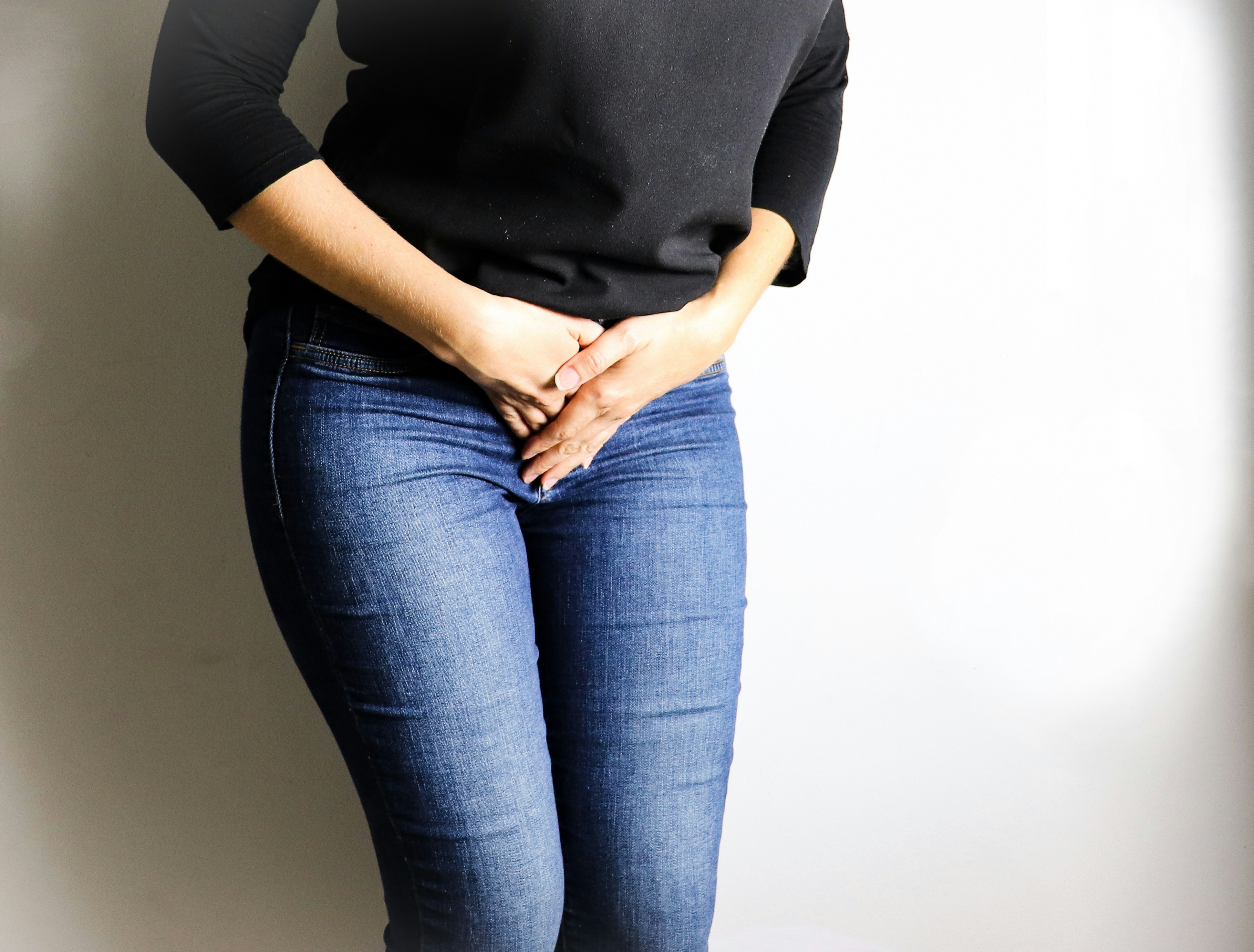 woman in black long sleeve shirt and blue denim jeans